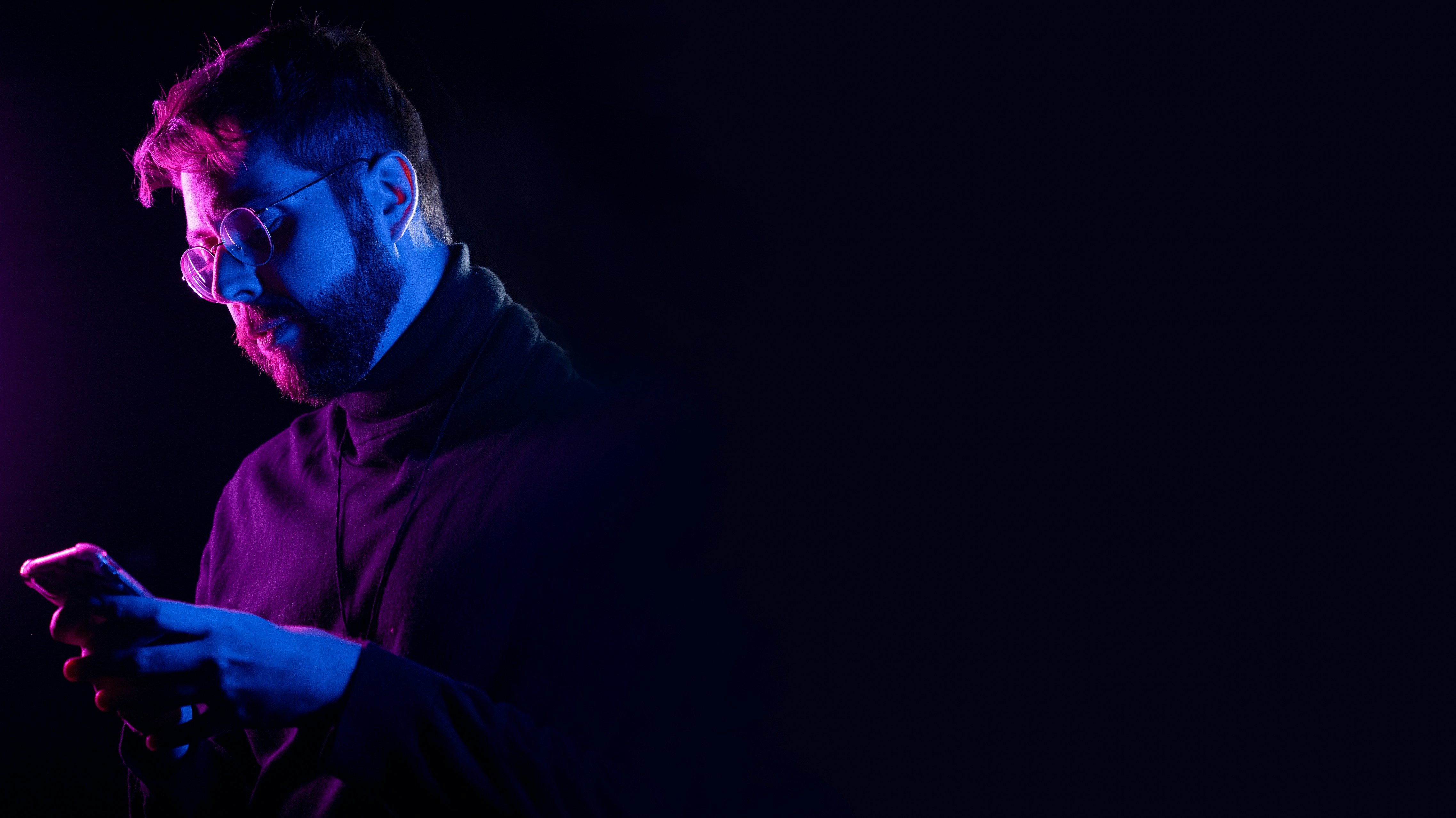 Man stands in darkness, consumed by social media addiction