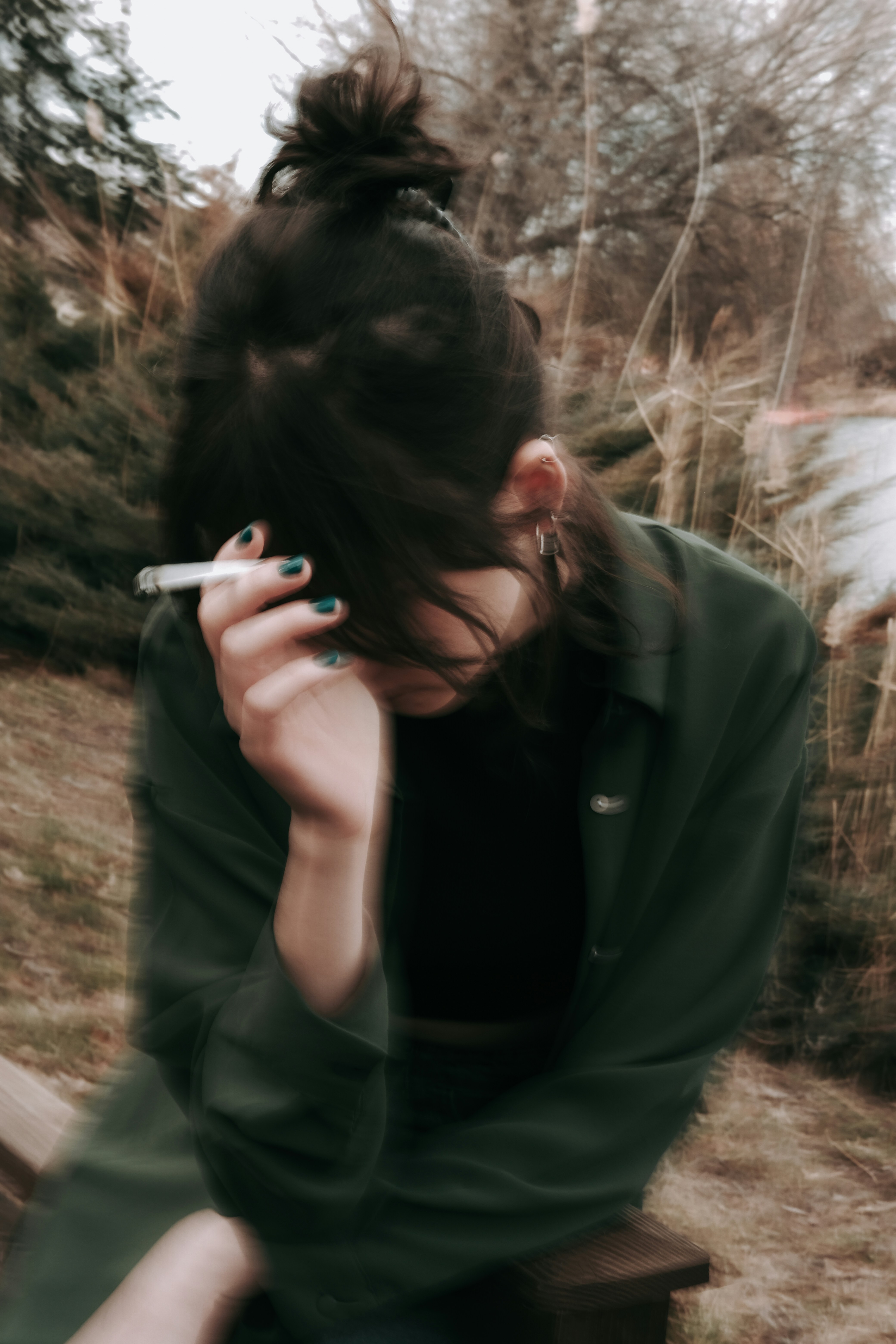 An upset woman smoking a cigarette fights a relapse trigger