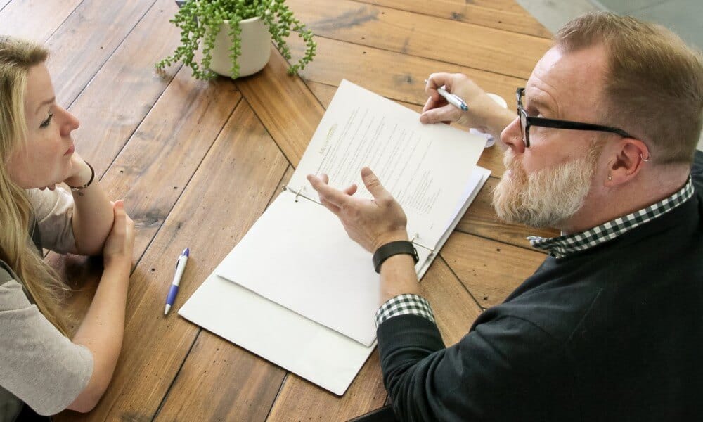 Recovery Coach Bill Blaber discussing sober living and sobriety goals with a female client in recovery