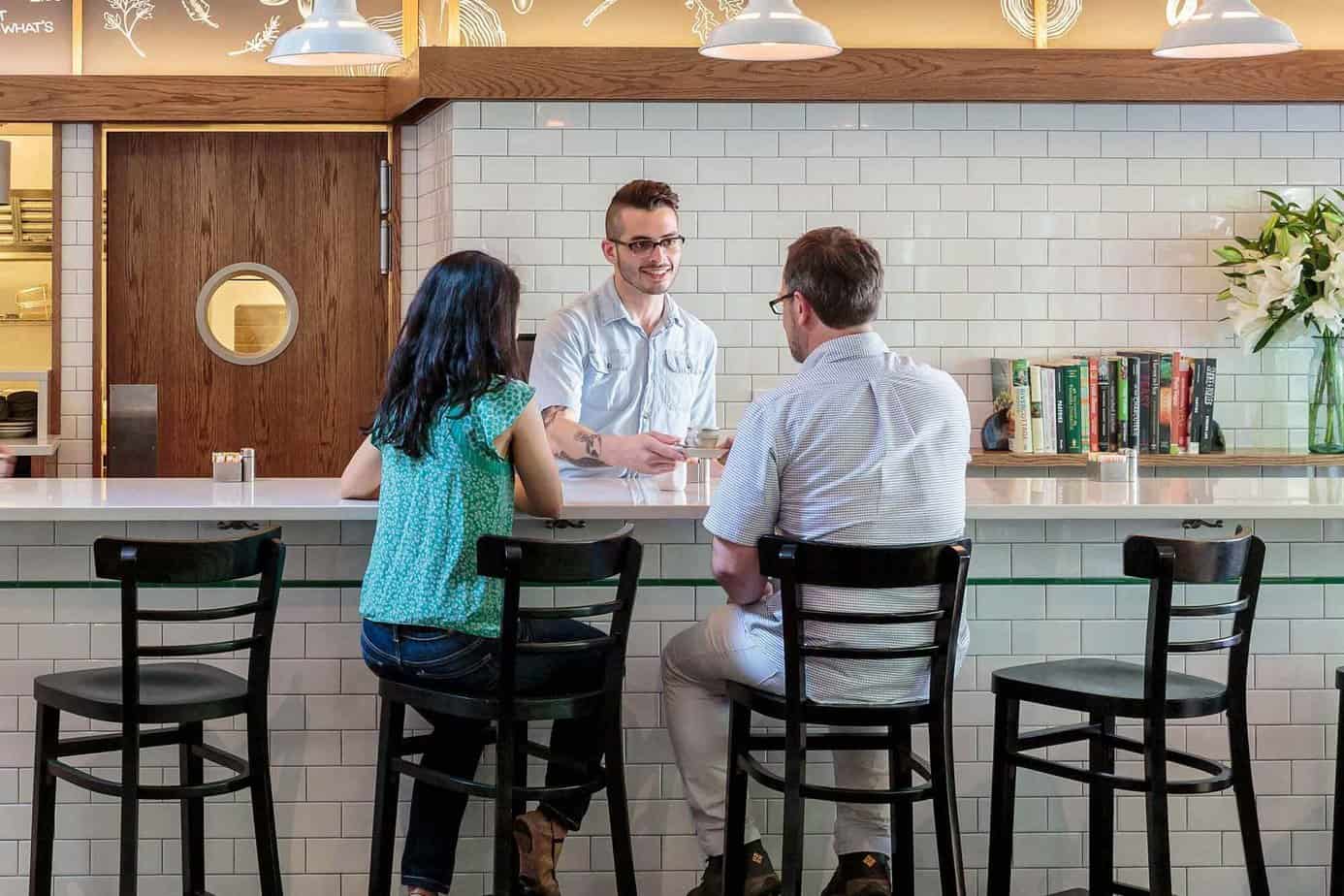 A man who is in long term residential treatment serving two customers at Mountainside Café