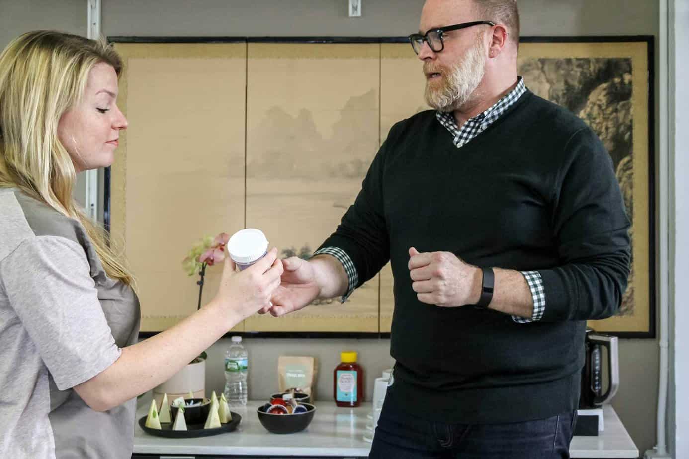 Mountainside treatment center recovery coach giving a drug rehab patient a cup for urine analysis.