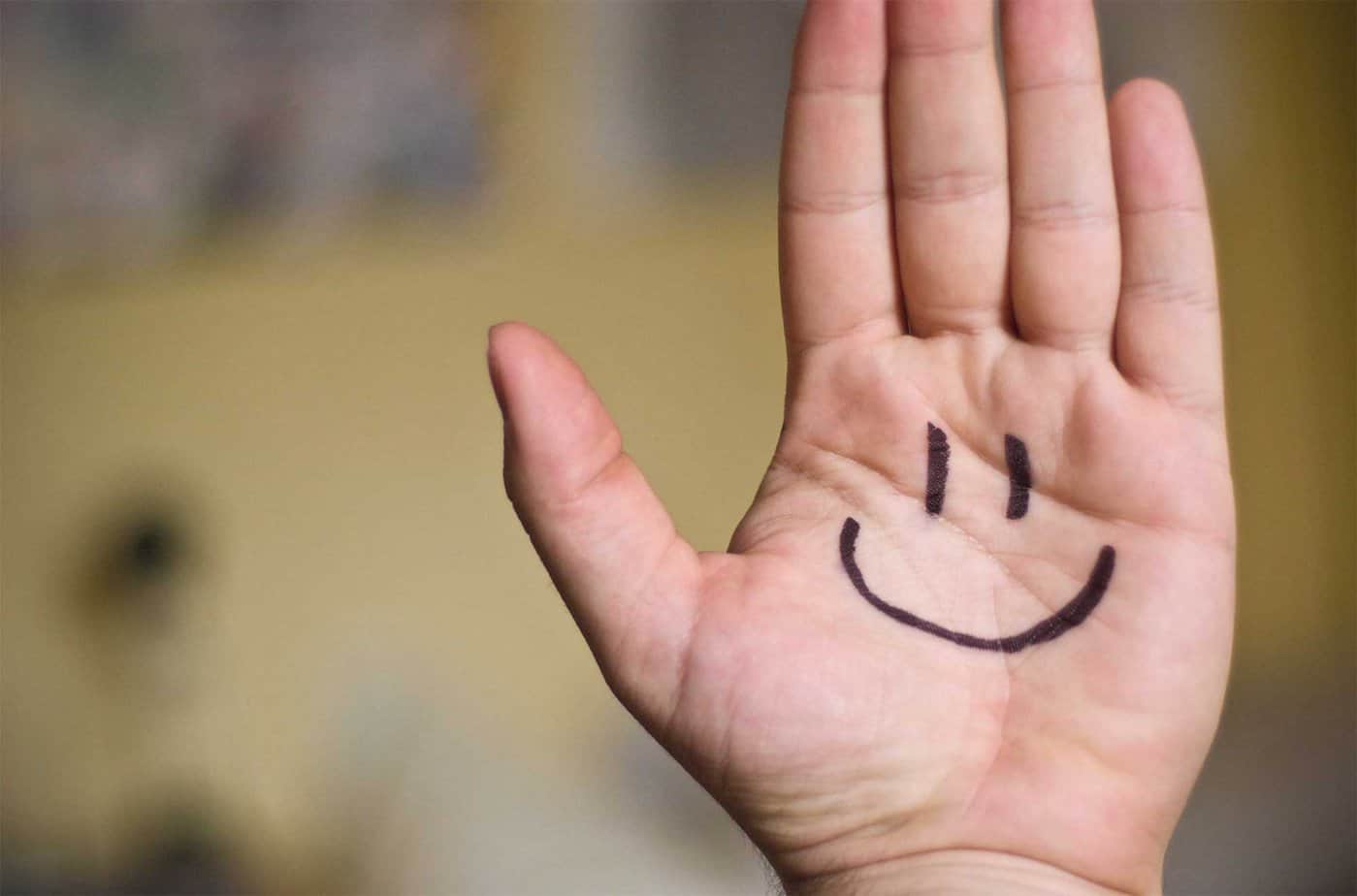 hand with smile drawn on