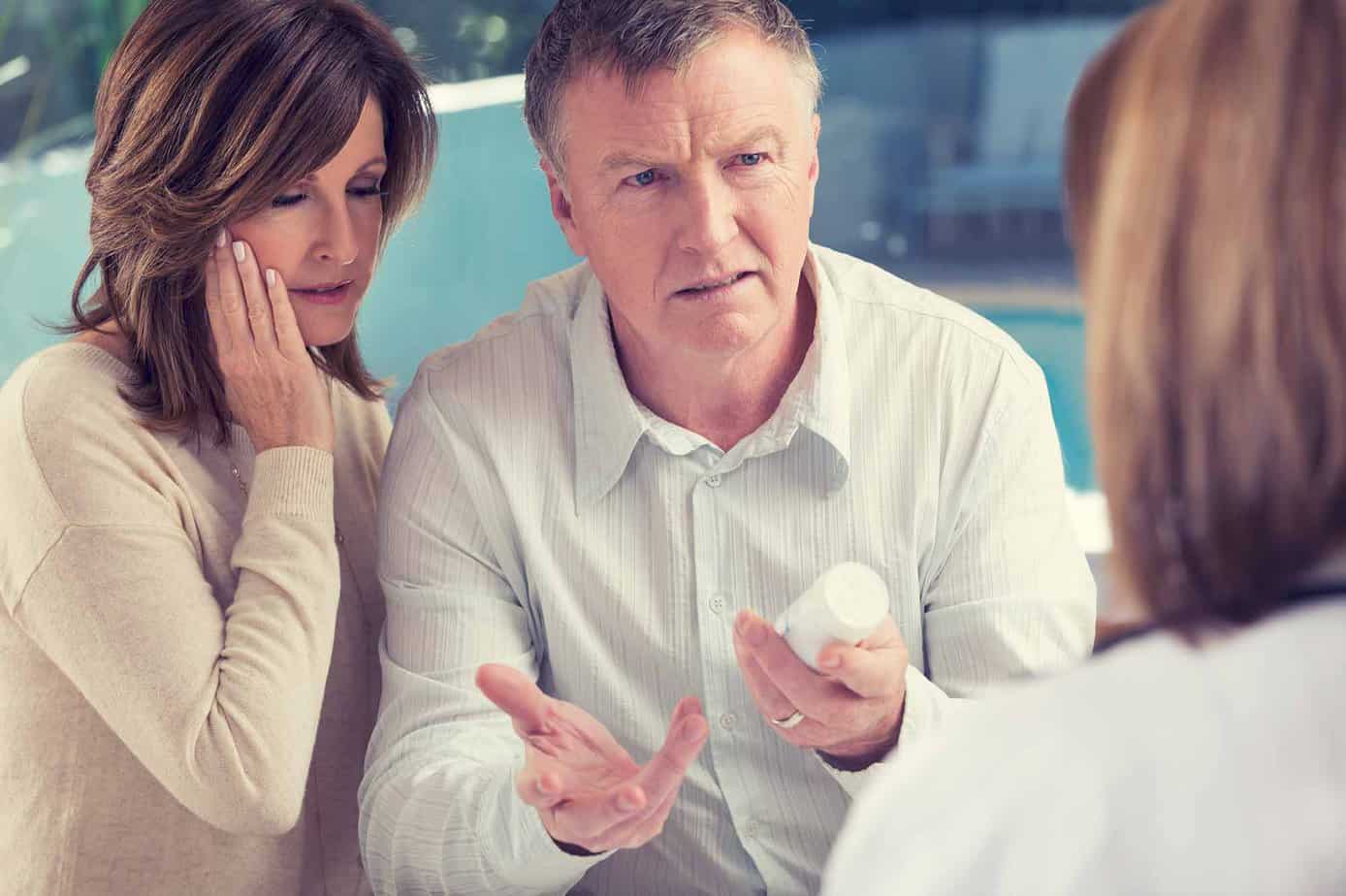 Parents worriedly speaking to daughter about painkiller use