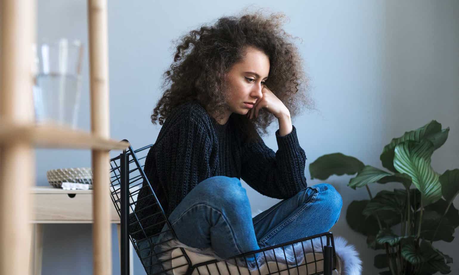 sad woman sitting on chair depressed