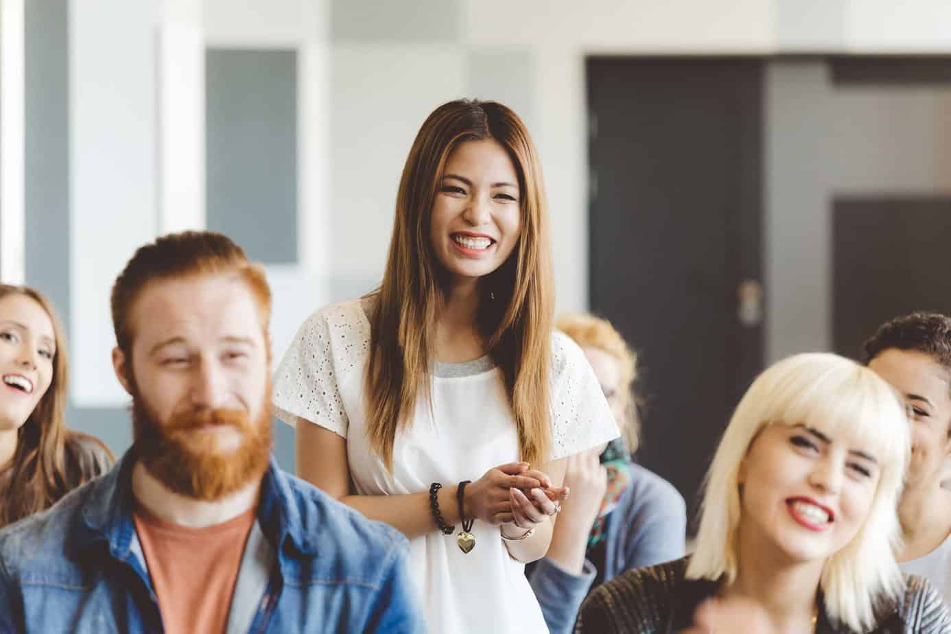 woman in a 12 steo meeting smiling