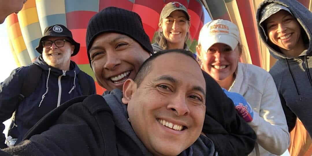 group photo of Mountainside Alumni posing behind hot air balloons