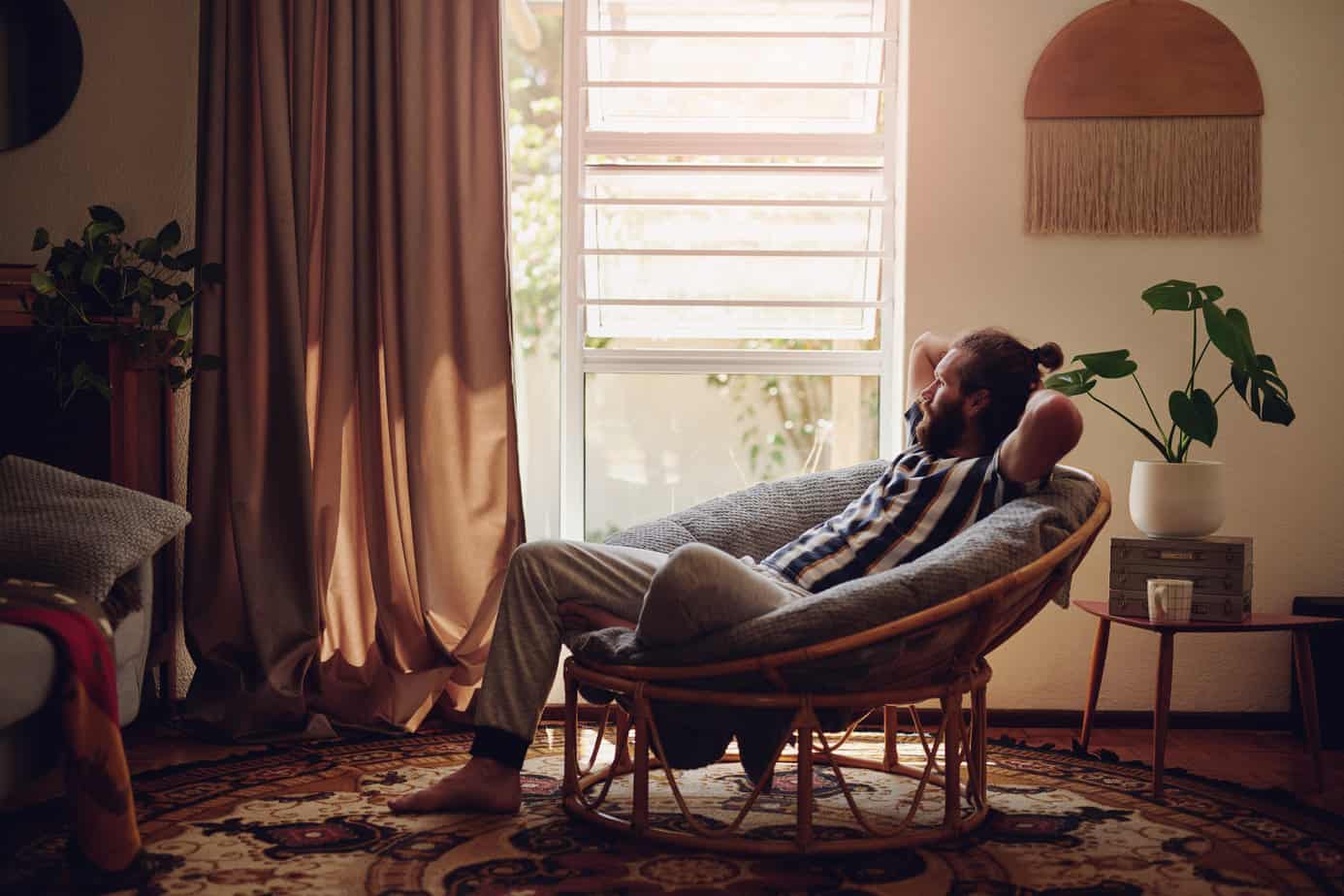 man relaxes in reclining chair by window in living room