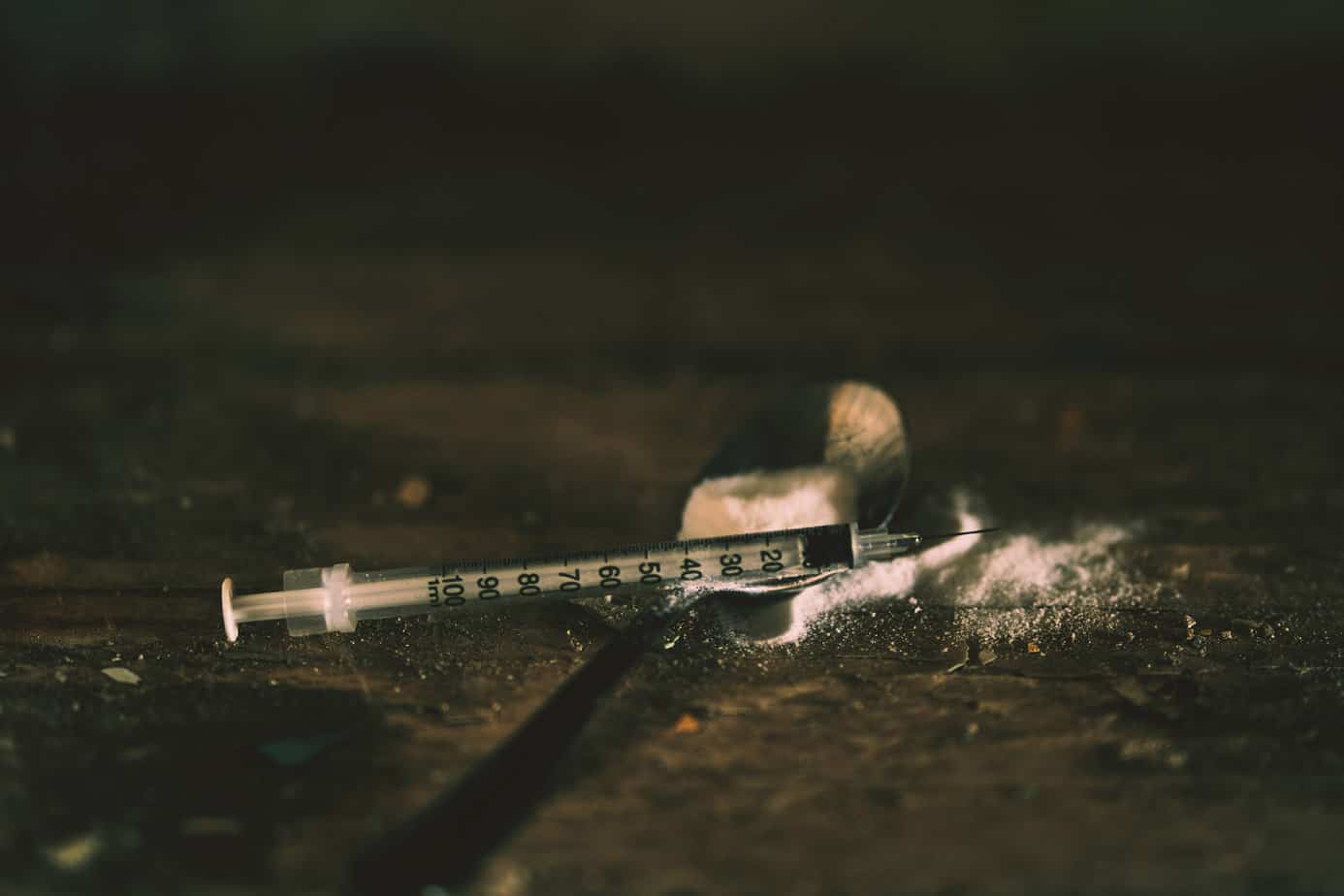 used needle and drug residue on the pavement