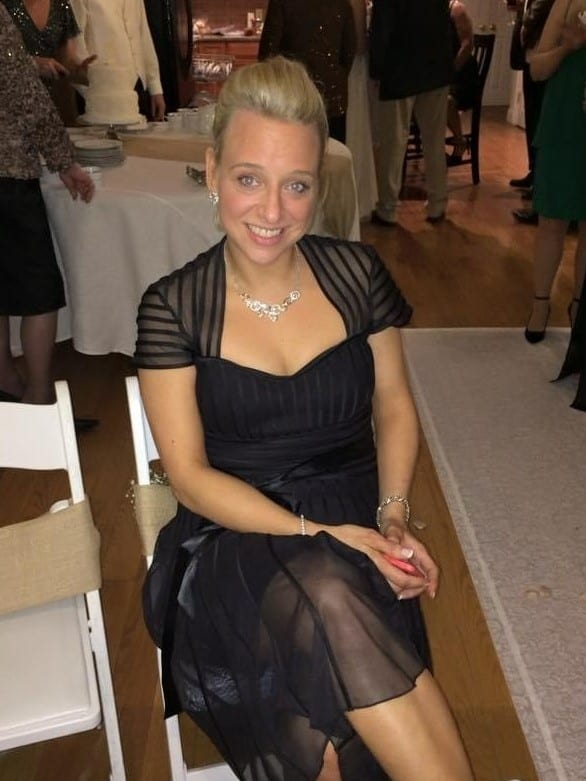 woman in black dress sitting at table in restaurant