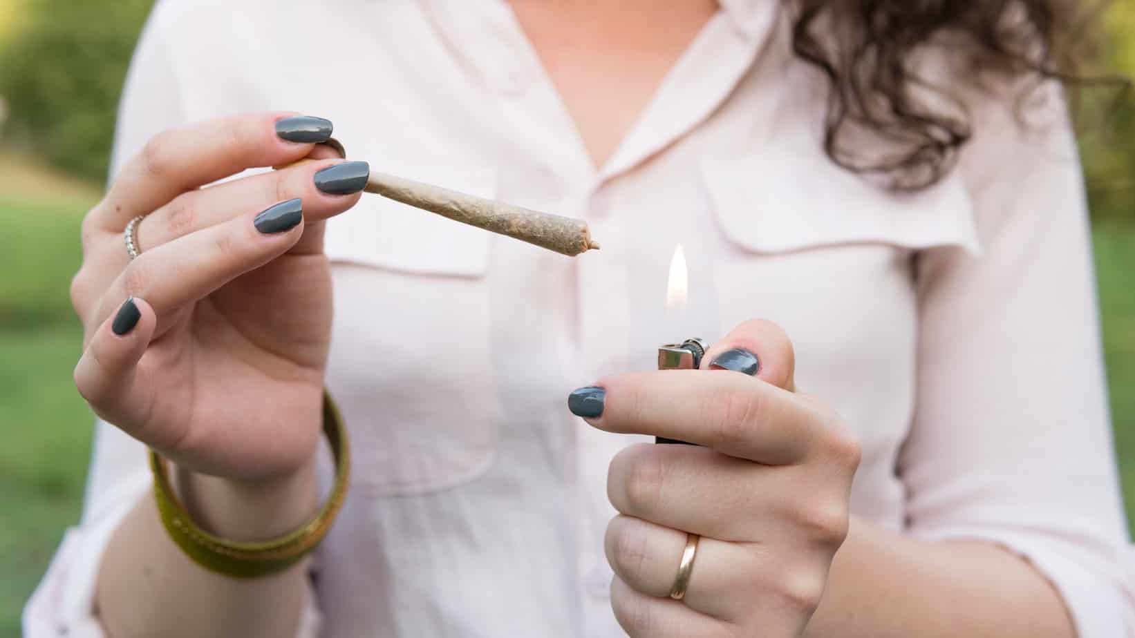 woman lighting up blunt close up
