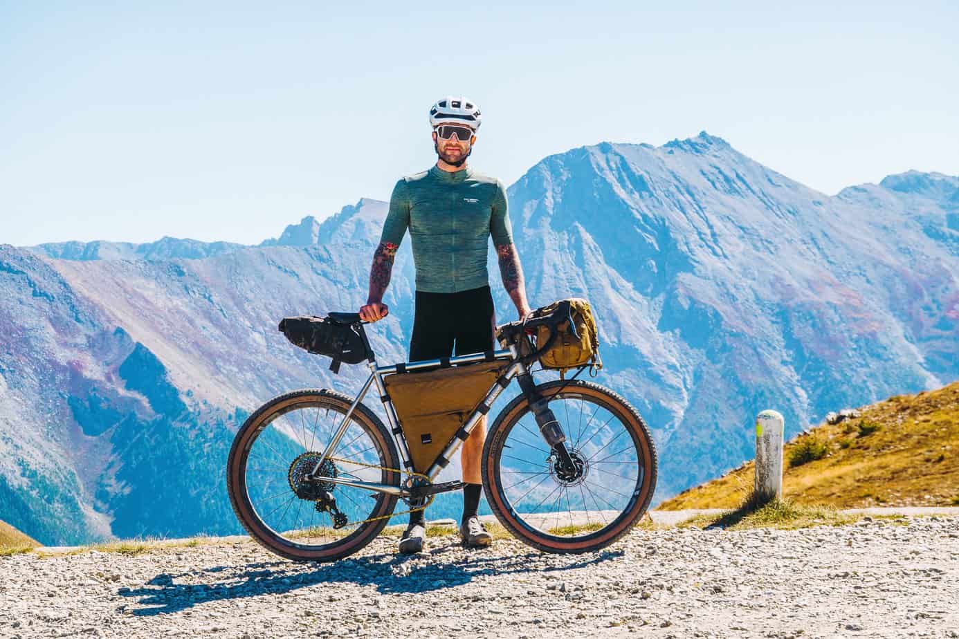 nik k alumni standing behind bike