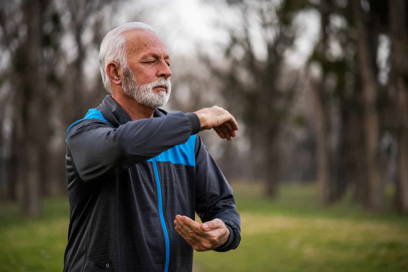 older man practicing qigong outdoors