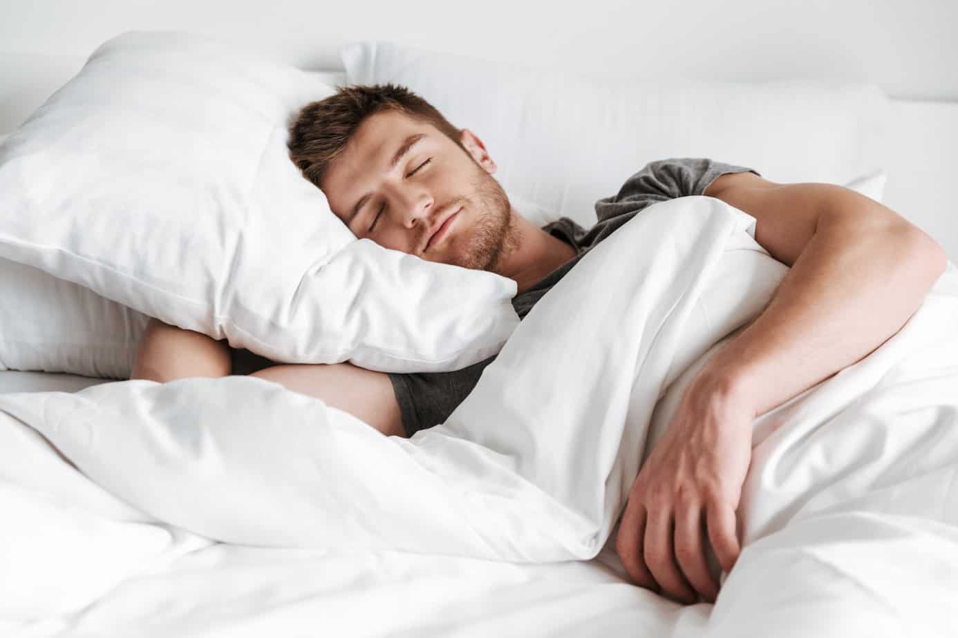 man sleeping peacefully in bed