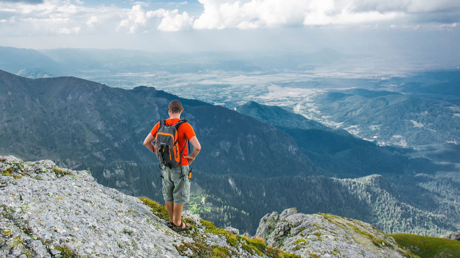 Man hiking and looking at a beautiful vista.