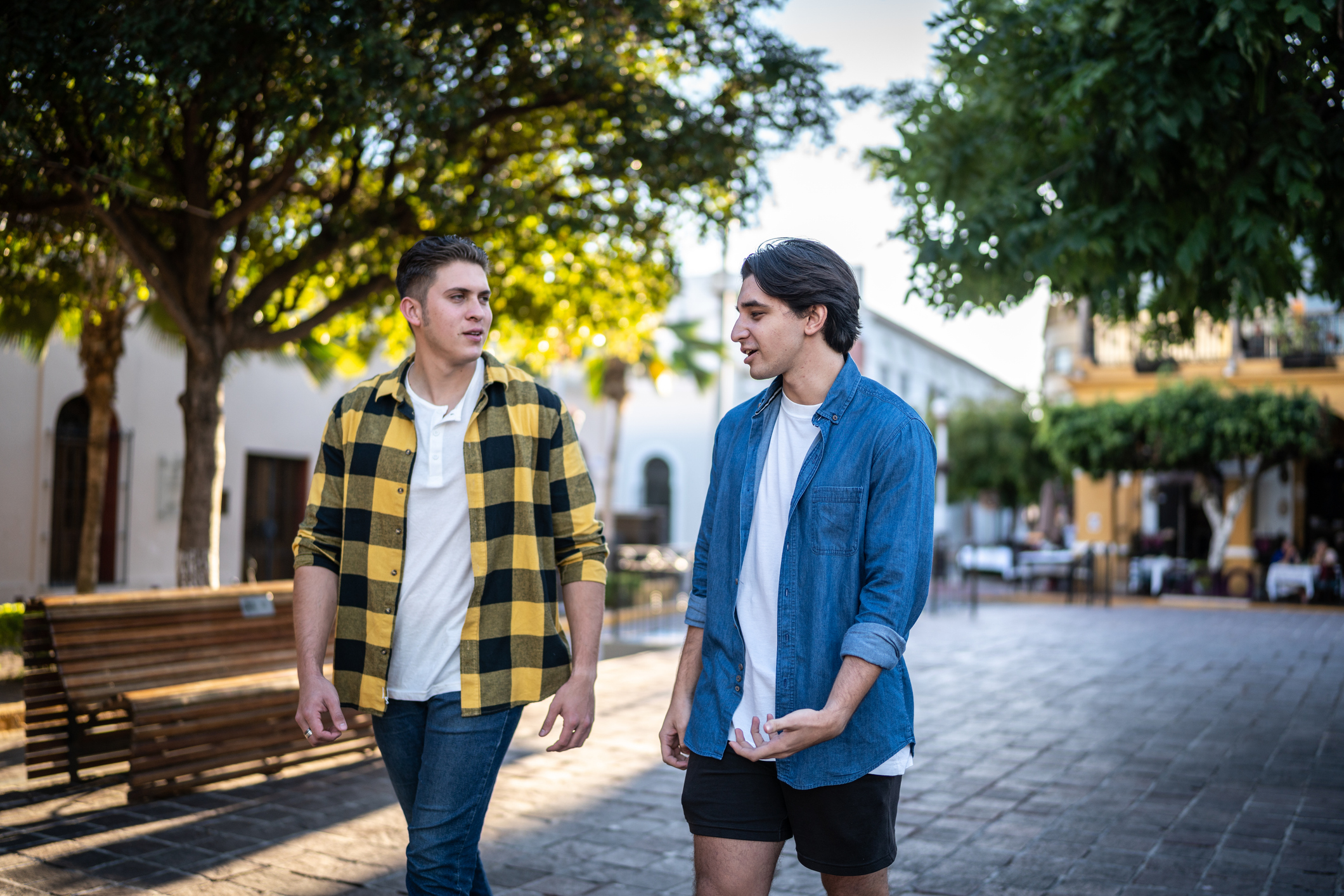 alcoholic anonymous AA sponsor walking with sponsee outside on street