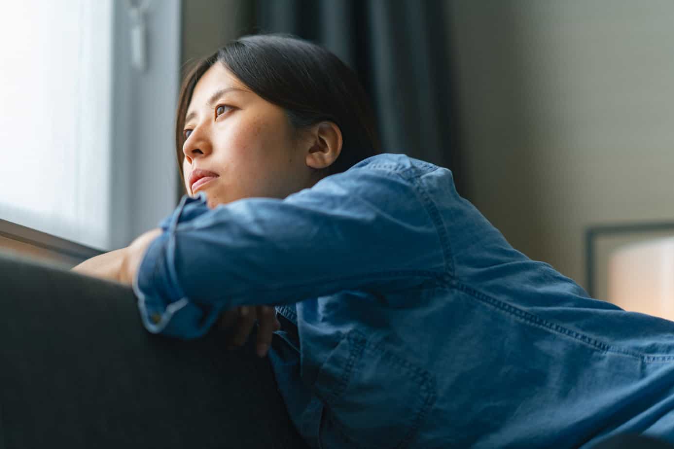 woman struggling with drug and alcohol cravings looking out the window