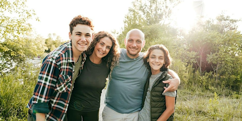 happy family hugging in nature