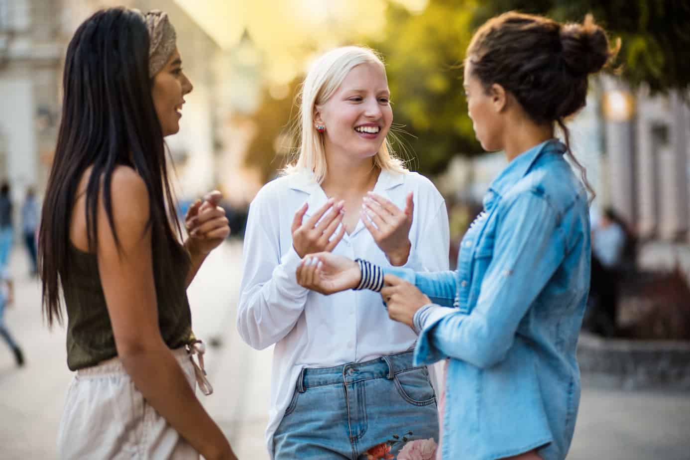 group of women in sobriety talking to each other outside in the street
