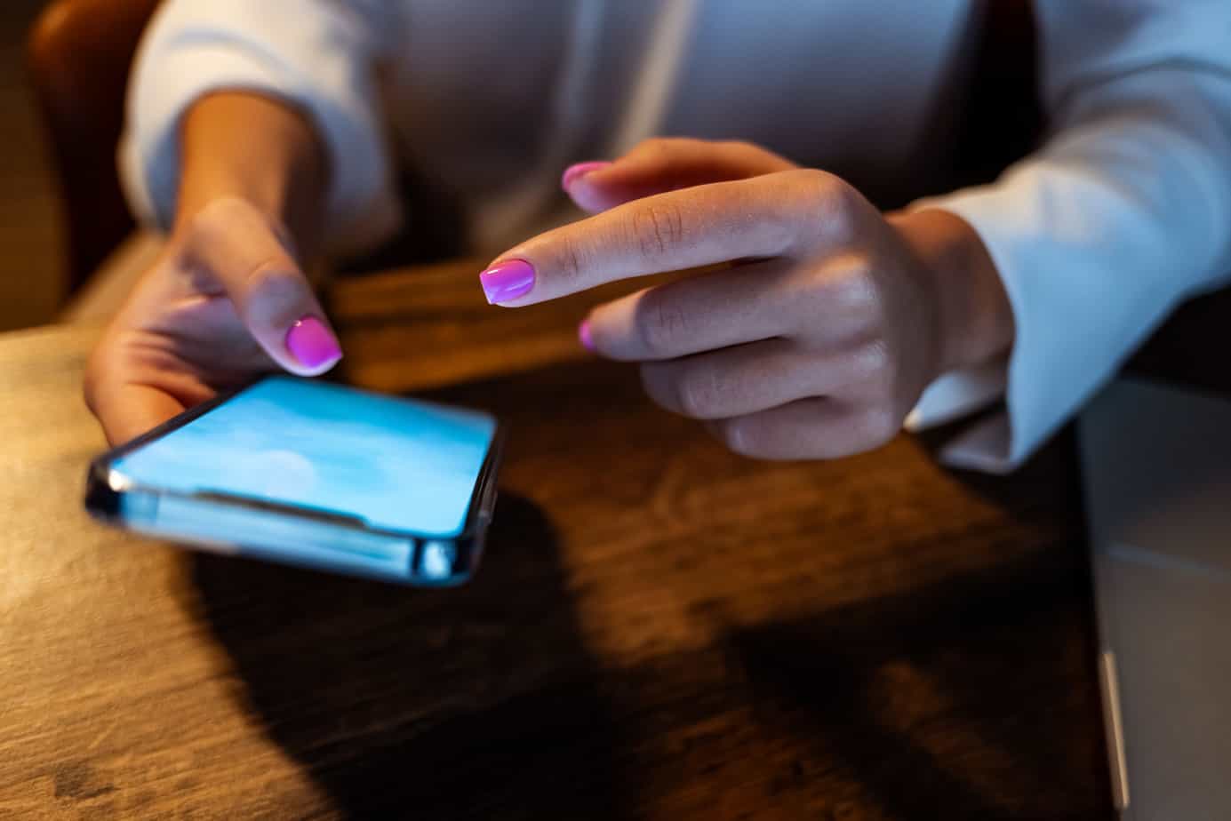 person scrolling on oscial media on iphone