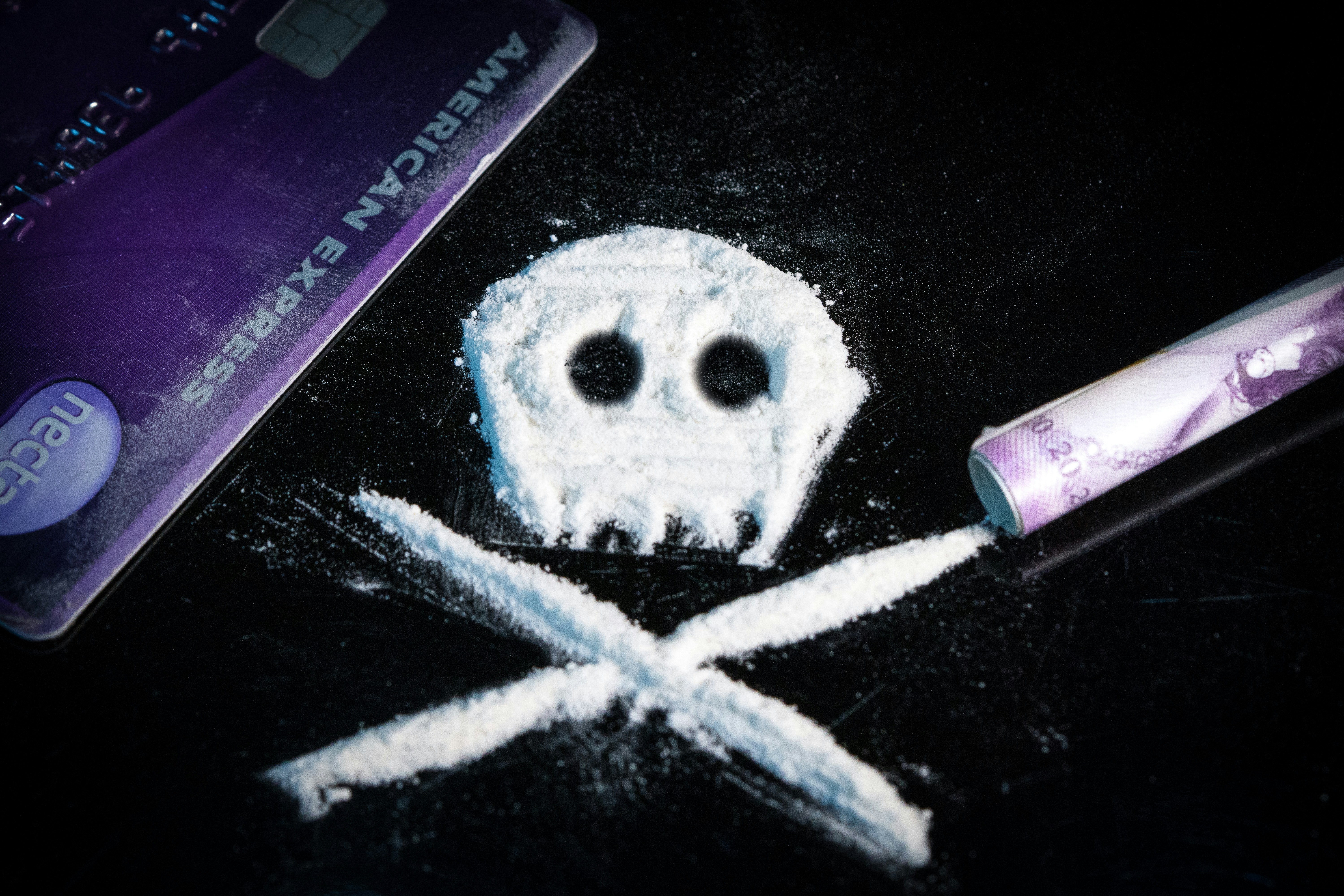 Photo of cocaine powder with paraphernalia, shaped into a skull and crossbones